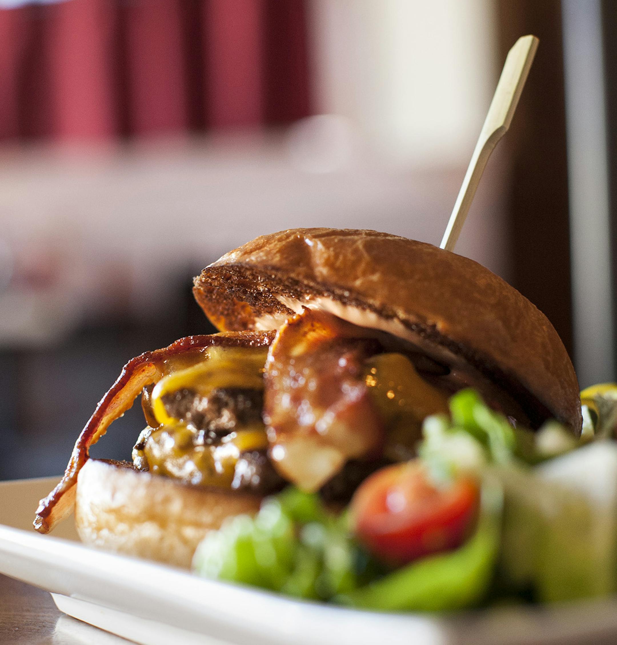 The Cheeseburger is Pat La Frieda beef, Patisserie 46 brioche, cheddar, and house pickles, with the option of adding Duroc bacon, at Lake and Irving in Minneapolis September 6, 2014. (Courtney Perry/Special to the Star Tribune)