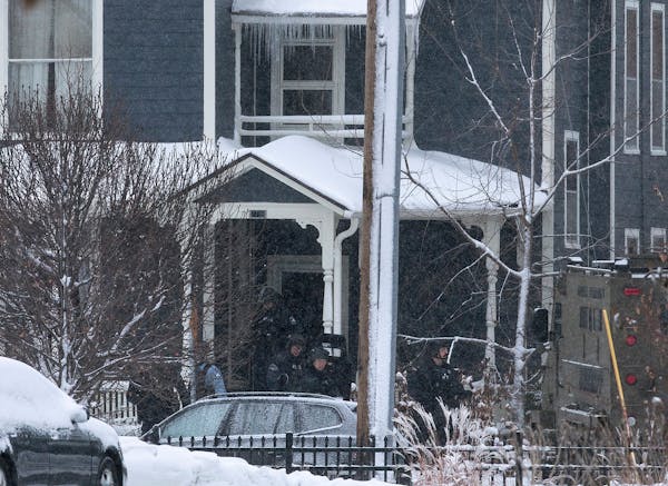 Police leave a home after breaching it at the 2700 block of Oakland Avenue South in Minneapolis.