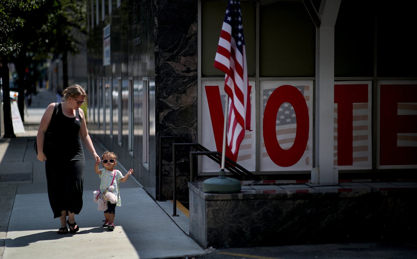 Christie Berkseth-Rojas with her daughter Sophie 2, walked out of the Early Vote Center after voting early in the primary election Monday August 6, 2018 in Minneapolis, MN. ] JERRY HOLT &#xef; jerry.holt@startribune