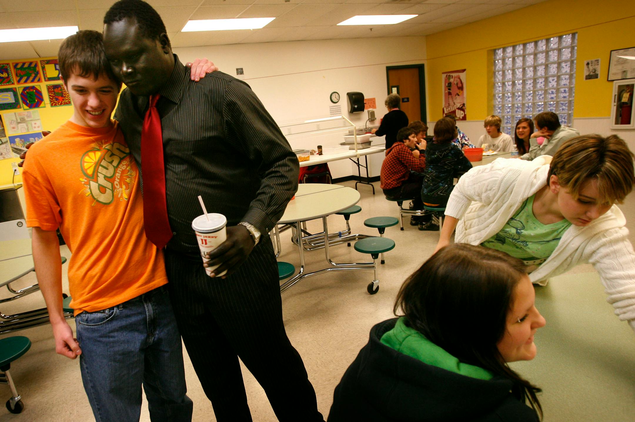 DAVID JOLES � djoles@startribune.comForest Lake, MN - Dec. 2, 2008 - Former lost boy Benjamin Ajak is greeted by Peter Schumacher, a sophomore at North Lake Academy in Forest Lake, where Ajak had lunch with students and visited the school. Ajak, 26, came to the U.S. on Sept. 11, 2001, and flew over the Twin Towers in New York as they were ablaze and then collapsed. Ajak co-authored a book entitled: "They Poured Fire on Us from the Sky," about his life in the Sudan, wandering Africa and later in