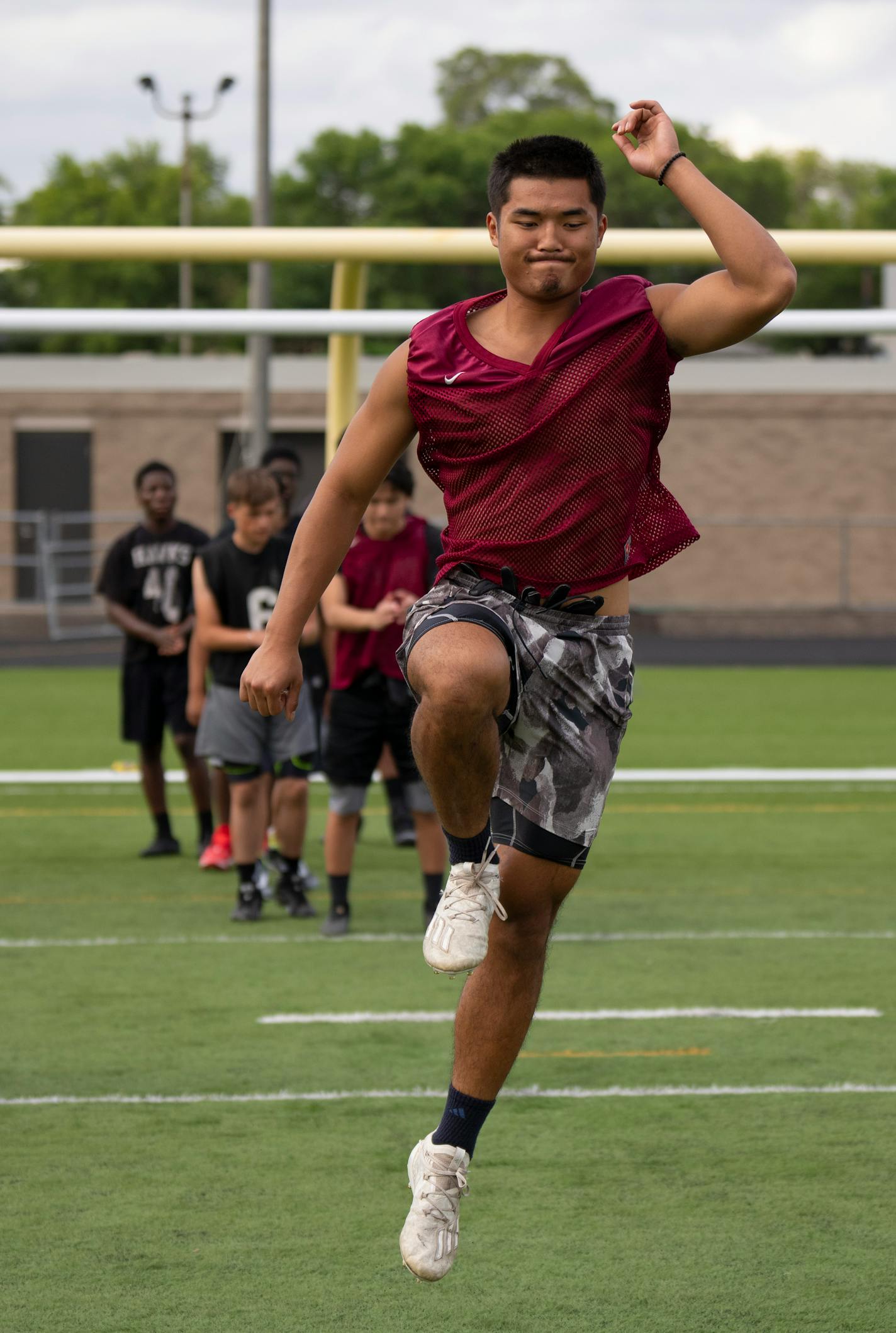 Running back Robert Htoo took part in warmups at the start of practice on the first day of football workouts Monday afternoon, August 15, 2022 at Harding High school in St. Paul. St. Paul high schools Harding and Humboldt combined their football programs last year. ] JEFF WHEELER • Jeff.Wheeler@startribune.com