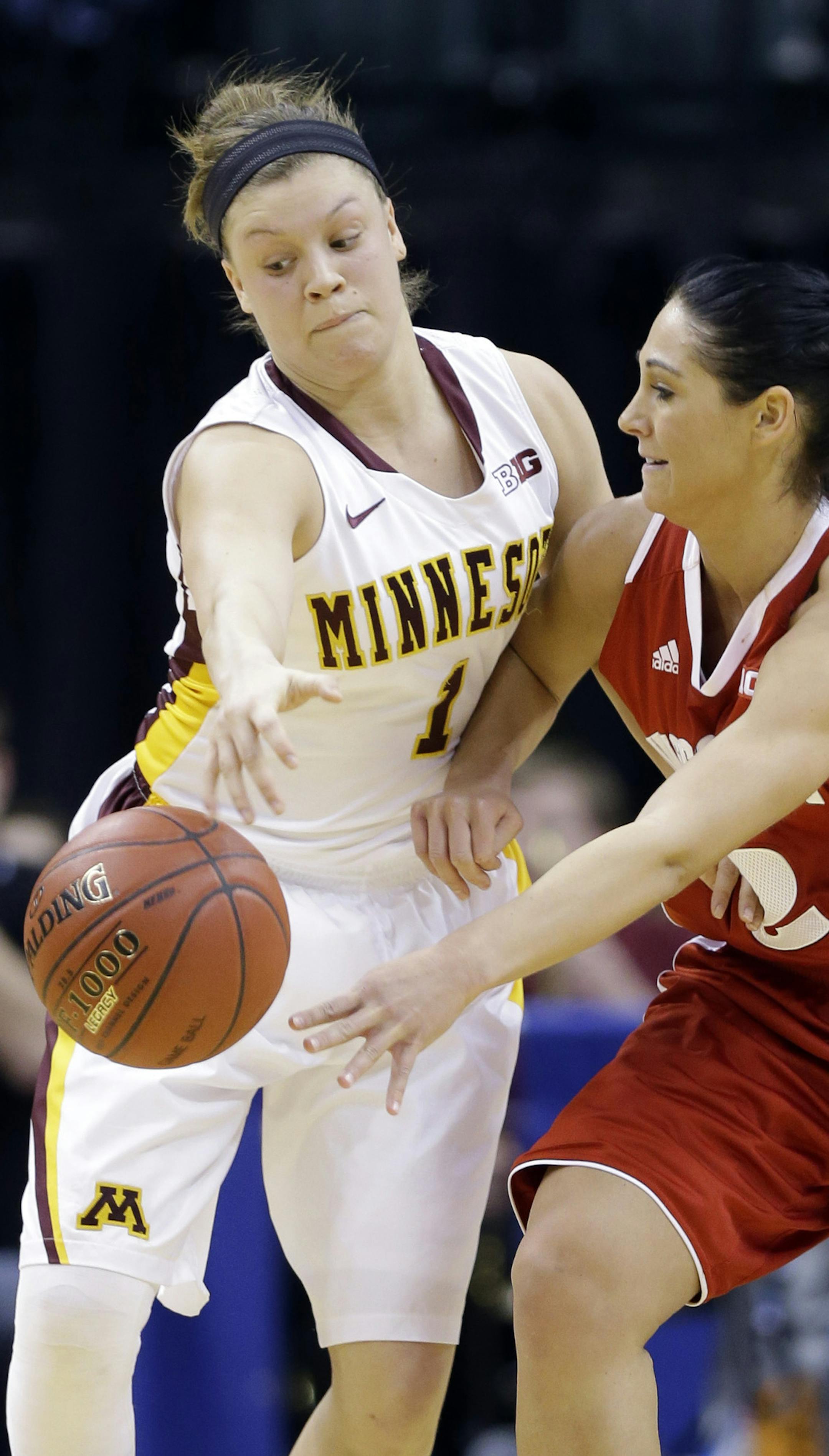 Minnesota guard Rachel Banham, left, steals the ball from Wisconsin guard Taylor Wurtz in the first half of an NCAA college basketball game in the opening round of the Big Ten Tournament in Indianapolis, Ind., Thursday, March 6, 2014. (AP Photo/Michael Conroy)
