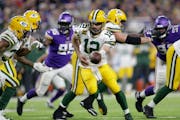 Packers quarterback Aaron Rodgers hands the ball off during the second half vs. the Vikings last season.