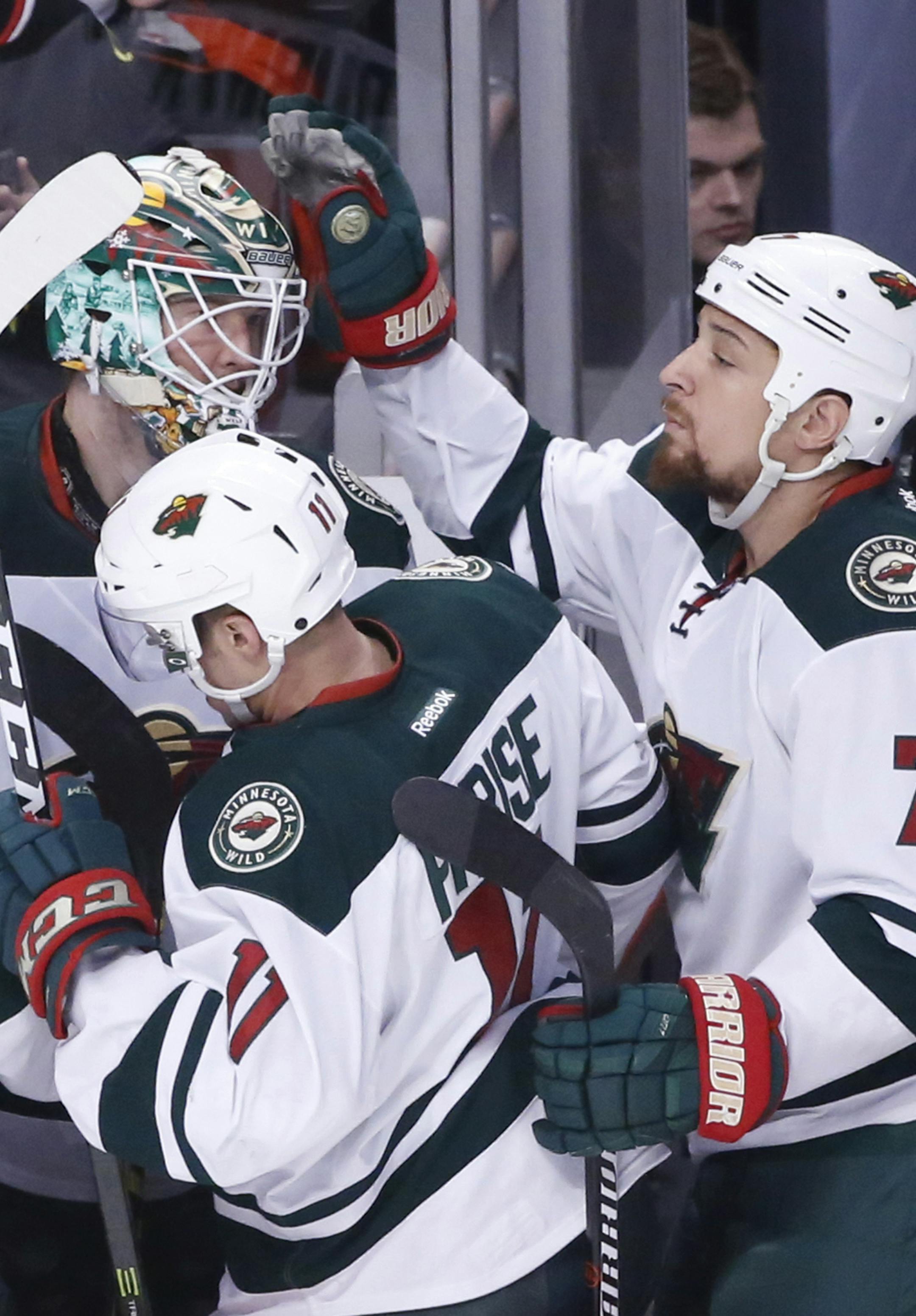 Minnesota Wild's Chris Stewart (7) acknowledges goalie Devan Dubnyk, as Dubnyk leaves the game during the first period of an NHL hockey game against the Chicago Blackhawks on Sunday, March 12, 2017, in Chicago. (AP Photo/Charles Rex Arbogast)