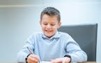Caden Baune, 9, winner of the 2024 Zaner-Bloser national handwriting competition for fourth-graders, competes in a handwriting contest against journal