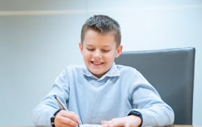 Caden Baune, 9, winner of the 2024 Zaner-Bloser national handwriting competition for fourth-graders, competes in a handwriting contest against journal