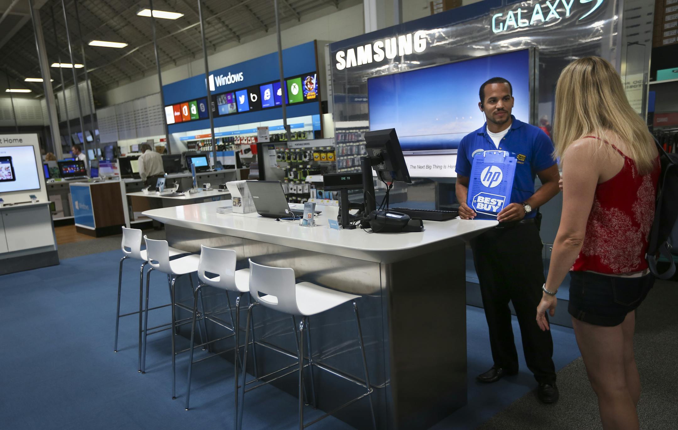 With its recent partnerships with Samsung and Microsoft, Best Buy has been one of the most aggressive proponent of the store within a store concept. Best Buy employee Phillip Stewart chatted with customer Karen Karpenko in the Samsung store in Best Buy in Richfield, Minn. on Wednesday, July 10, 2013.