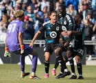 Minnesota United midfielder Tani Oluwaseyi (14) is congratulated by teammates after scoring the tying goal in stoppage time against the Columbus Crew.