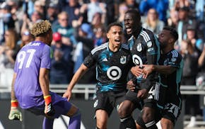 Minnesota United midfielder Tani Oluwaseyi (14) is congratulated by teammates after scoring the tying goal in stoppage time against the Columbus Crew.