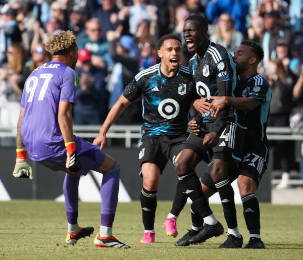 Minnesota United midfielder Tani Oluwaseyi (14) is congratulated by teammates after scoring the tying goal in stoppage time against the Columbus Crew.