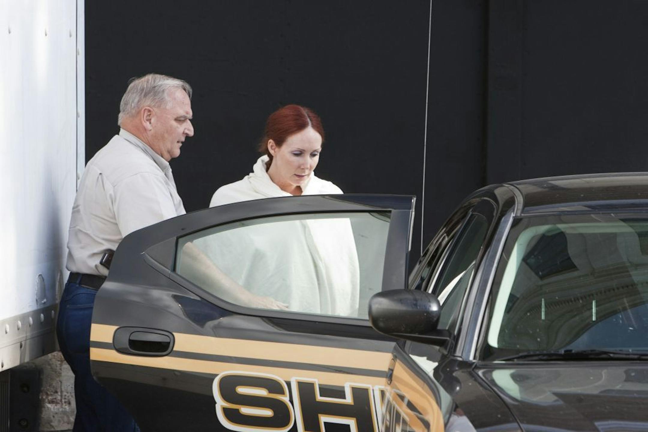 Shannon Richardson is placed into a Titus County Sheriff's car after an initial appearance Friday, June 7, 2013 at the federal building Texarkana, Texas. The FBI says Shannon Richardson admitted sending ricin-tainted letters to President Barack Obama and New York City Mayor Michael Bloomberg, but only after trying to pin it on her husband.
