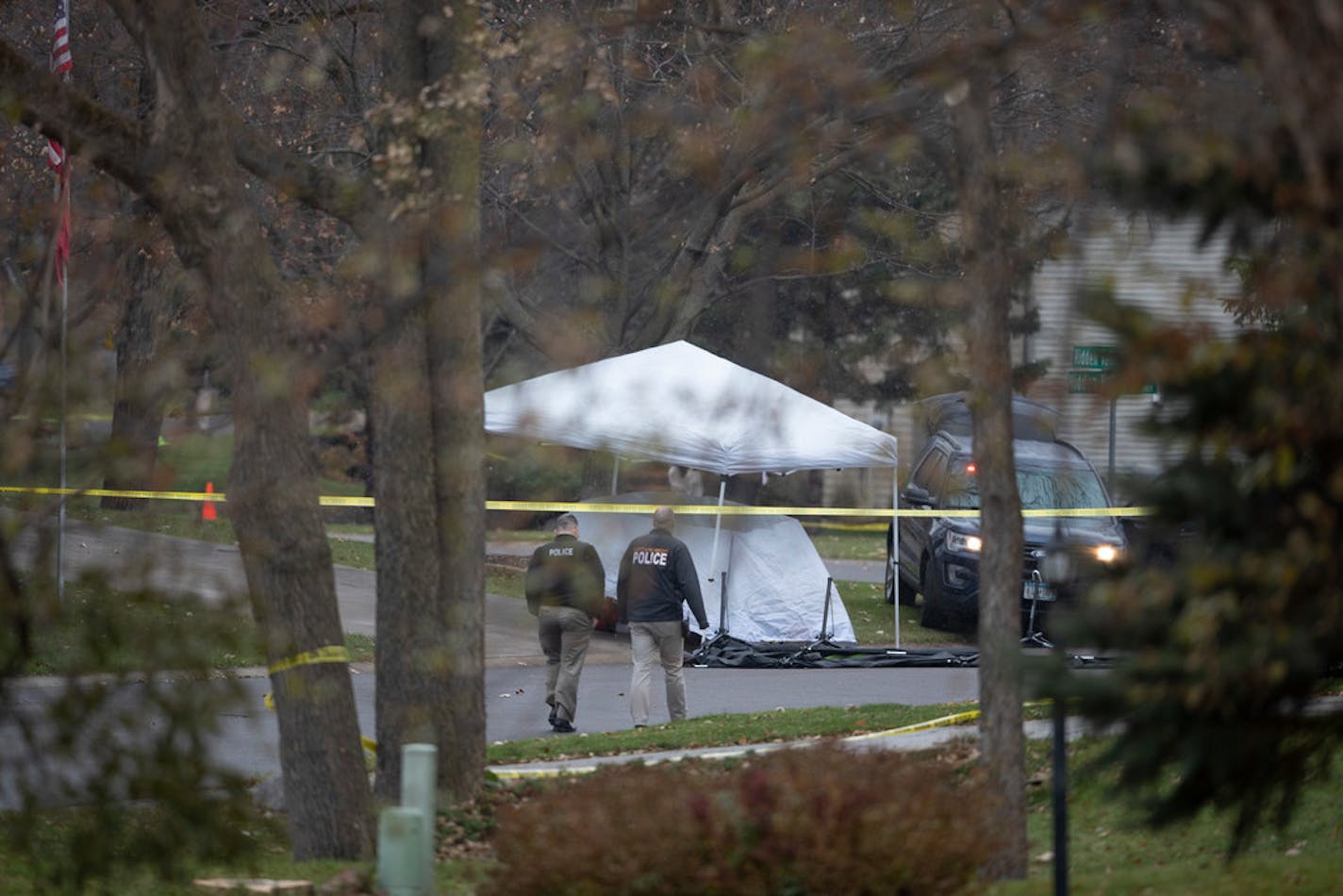 Police officers walked by the scene where a suspect was shot and killed by Police in the 7400 block of Hidden Valley Court South in Cottage Grove on Monday, Nov. 4, 2019.