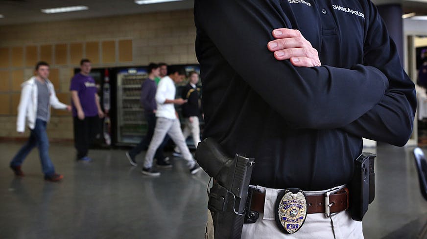 School resource officer Trent Wurtz carries a Glock 357 handgun on his side along with his Chaska Police Department badge as he periodically monitors the hallways and lunch area at Chaska High School.