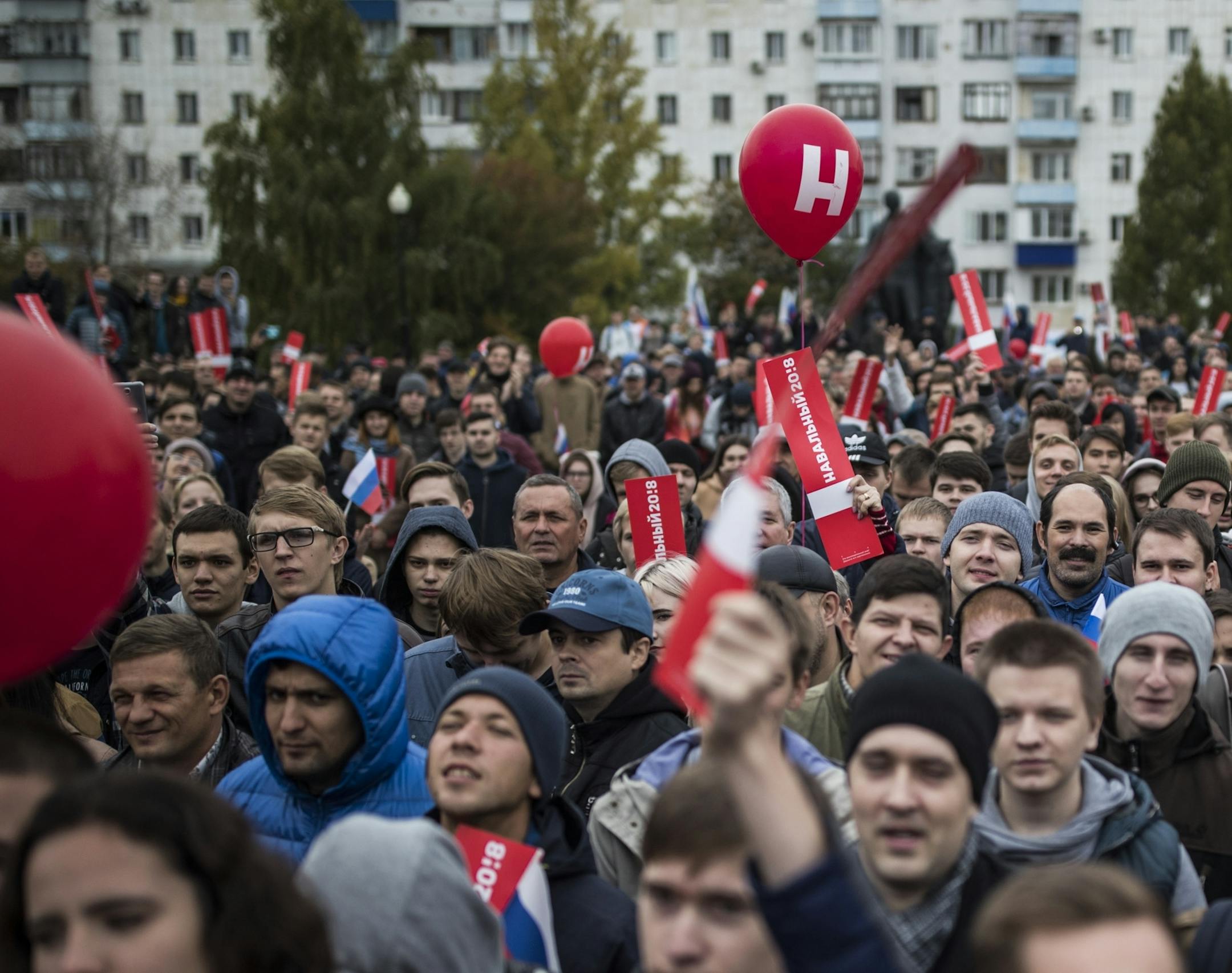 People listen to Russian opposition leader Alexei Navalny during a rally in Orenburg, 1400 kilometres (875 miles) east from Moscow, Russia, Saturday, Sept. 30, 2017. Navalny, who announced his presidential bid last year, has organized a grassroots campaign in Russian regions to support his nomination. (Evgeny Feldman/Navalny Campaign via AP)