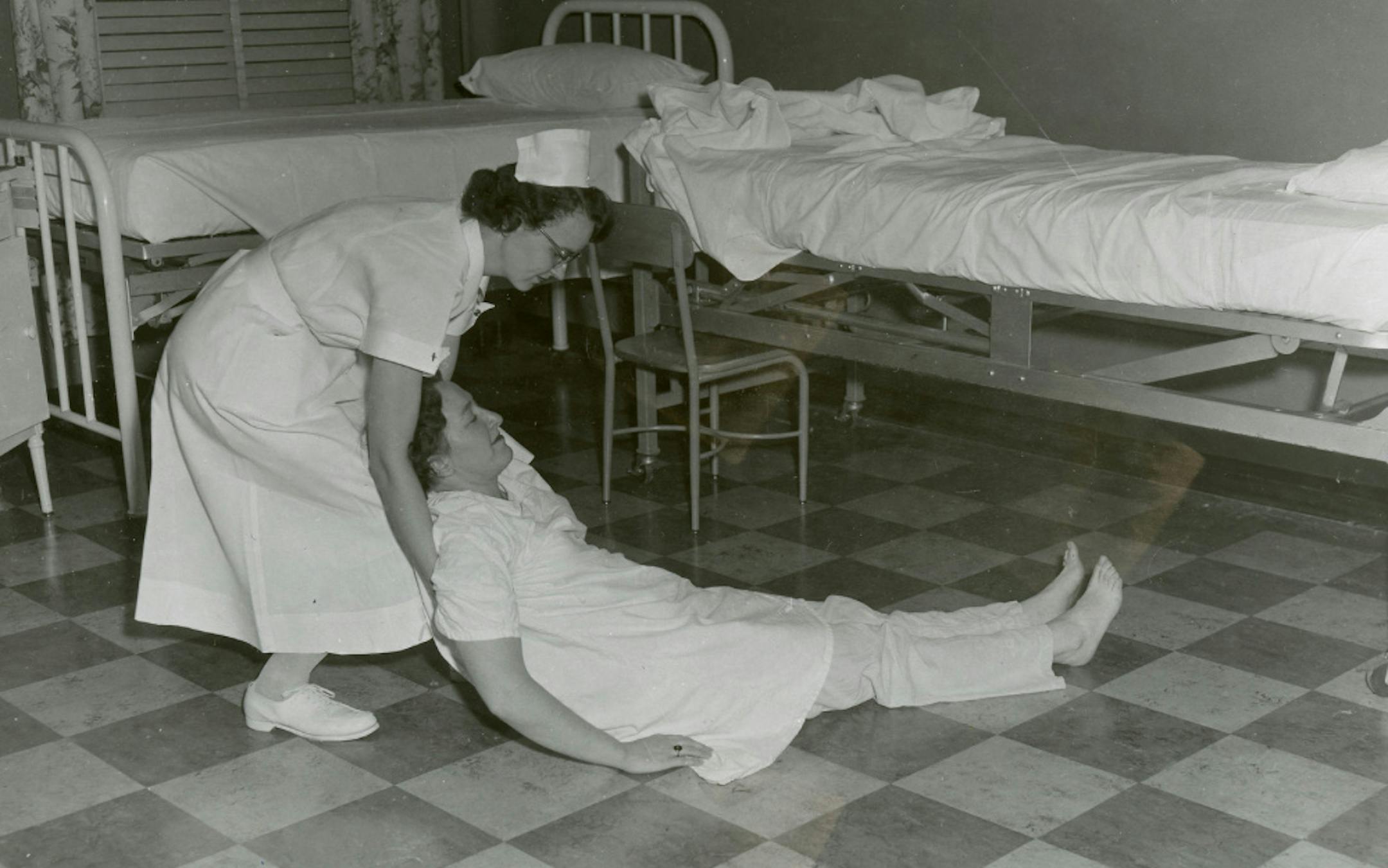 Rescue of Patient Demonstration Drag the patient from the room. ca. 1957 Credit: City of Minneapolis archives
