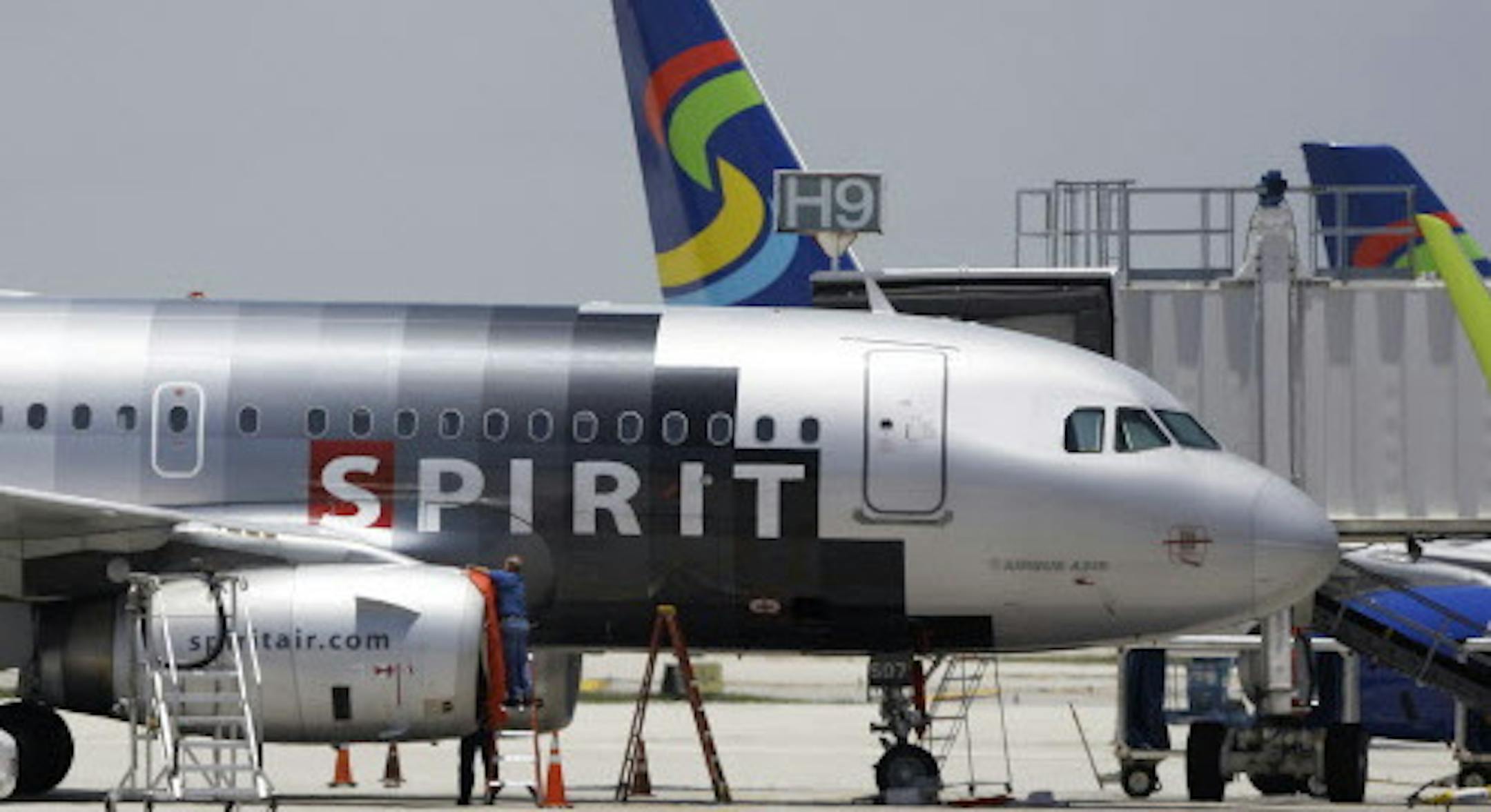 FILE - In this file photo taken June 13, 2010, a Spirit Airlines airplane sits on the tarmac at Fort Lauderdale-Hollywood International Airport in Fort Lauderdale, Fla. Spirit Airlines passengers may want to get to the airport a little earlier than normal Sunday as a new fee on carry-on bags takes effect.