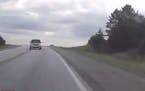 This image from a dashcam video shows a Minnesota driver swerving onto the shoulder to avoid a head-on crash with a distracted driver who crossed the 