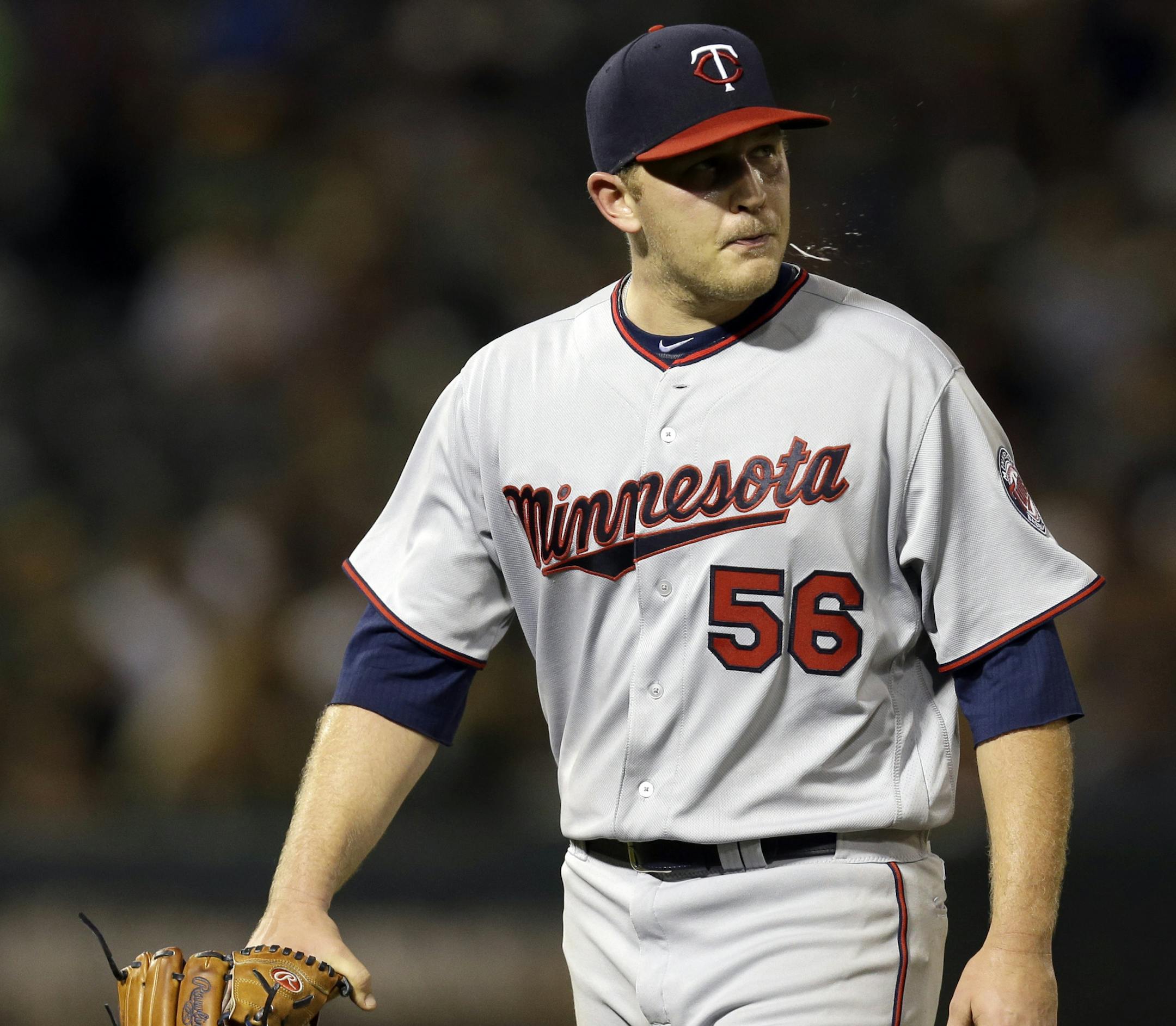Minnesota Twins pitcher Tyler Duffey walks off the field after being removed from the baseball game against the Oakland Athletics in the fifth inning Tuesday, May 31, 2016, in Oakland, Calif. (AP Photo/Ben Margot)