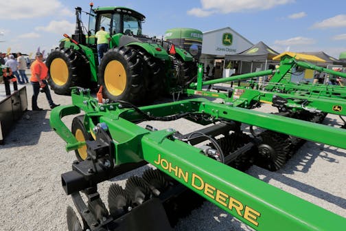 FILE - In this Sept. 10, 2019, file photo a John Deere tractor is on display at the Husker Harvest Days farm show in Grand Island, Neb. More than 10,000 Deere &amp; Co. workers appear ready to go on strike if negotiators can't deliver a new agreement by the end of Wednesday, Oct. 13, 2021. (AP Photo/Nati Harnik, File)