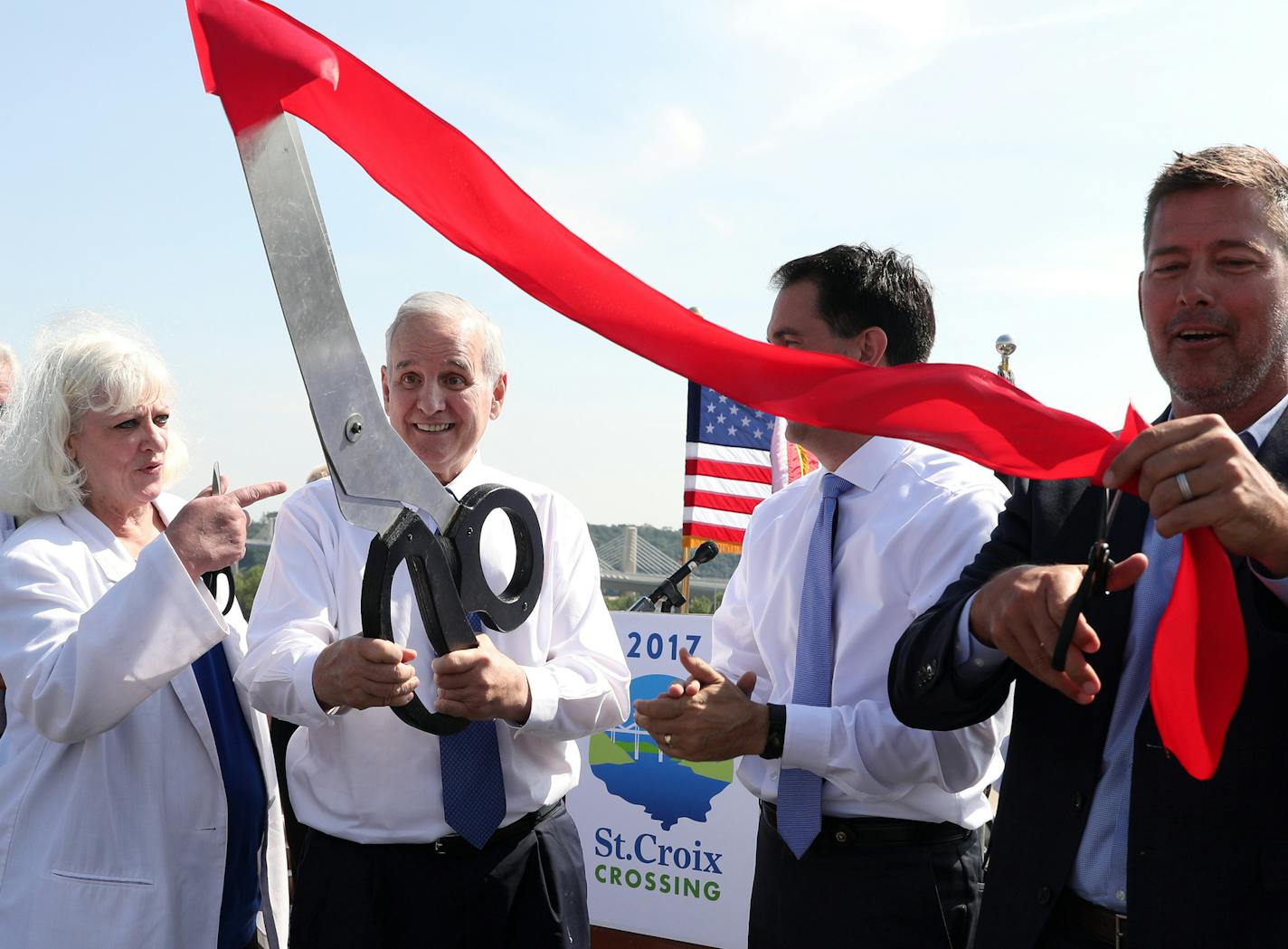 Minnesota Gov. Mark Mark Dayton looked on with laugher after his attempt at cutting the ribbon with oversized scissors was unsuccessful. ] ANTHONY SOUFFLE &#xef; anthony.souffle@startribune.com Officials held a ribbon-cutting ceremony for the new St. Croix River bridge Wednesday, Aug. 2, 2017 in Oak Park Heights, Minn.