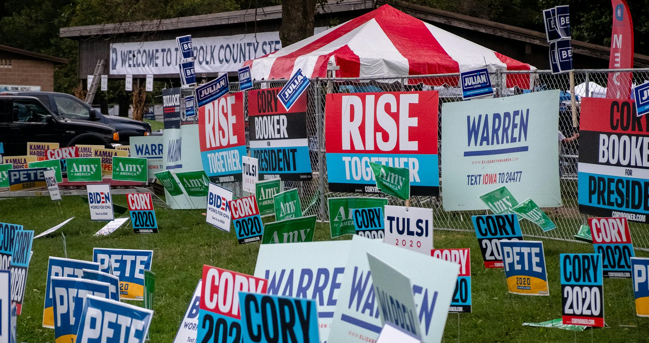 Democratic presidential candidates' campaign signs at the Polk County Democrats' annual Steak Fry in Des Moines, Iowa, on Saturday, Sept. 21, 2019. (Hilary Swift/The New York Times)