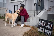 Hennepin County Commissioner Angela Conley walked her dog, Steve, in Minneapolis on Wednesday.
