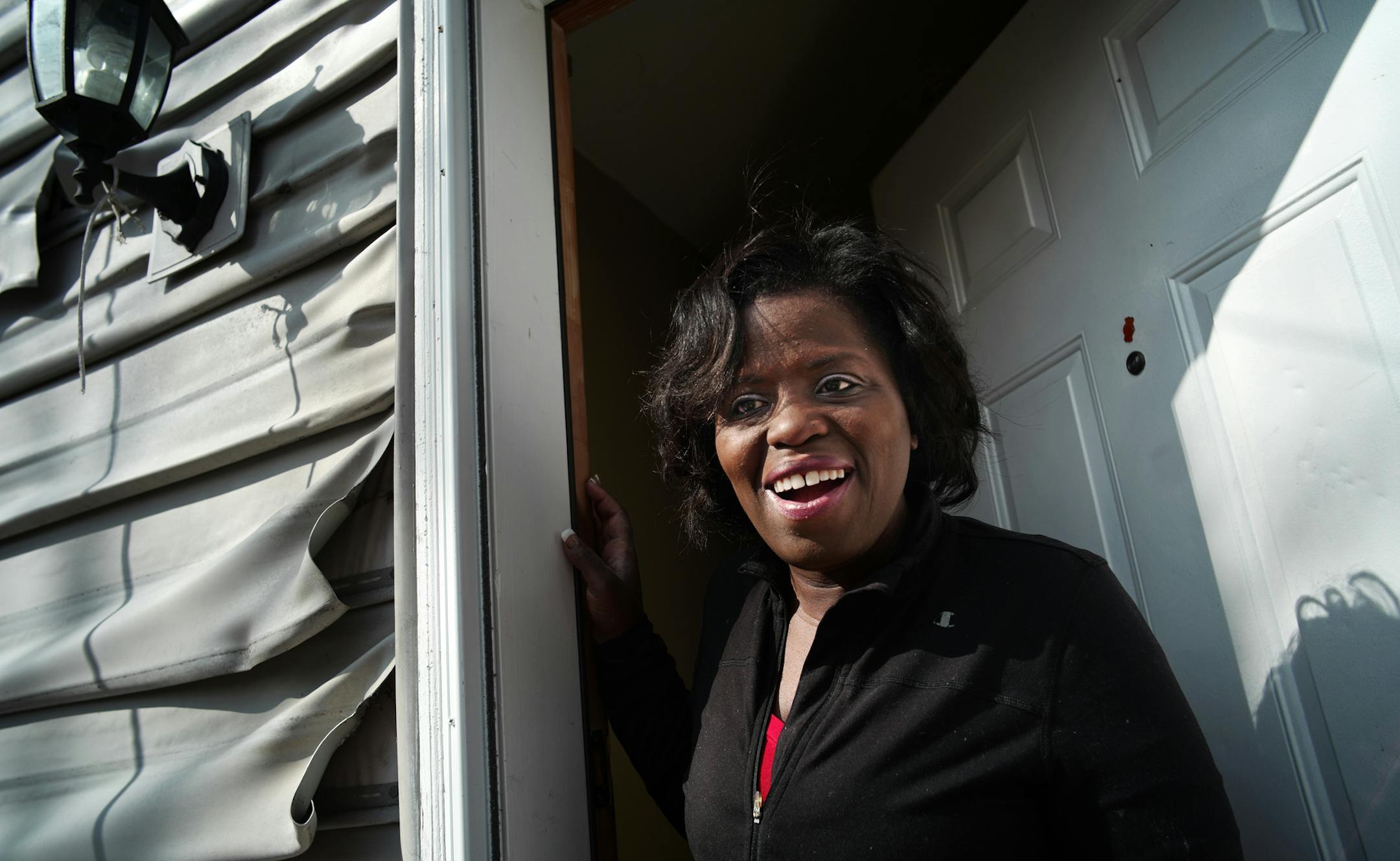 Tawanda Miller was pleased that her garage was being rebuilt after a fire burned it down and damaged the vinyl siding on her house. Volunteers donated both time and money.