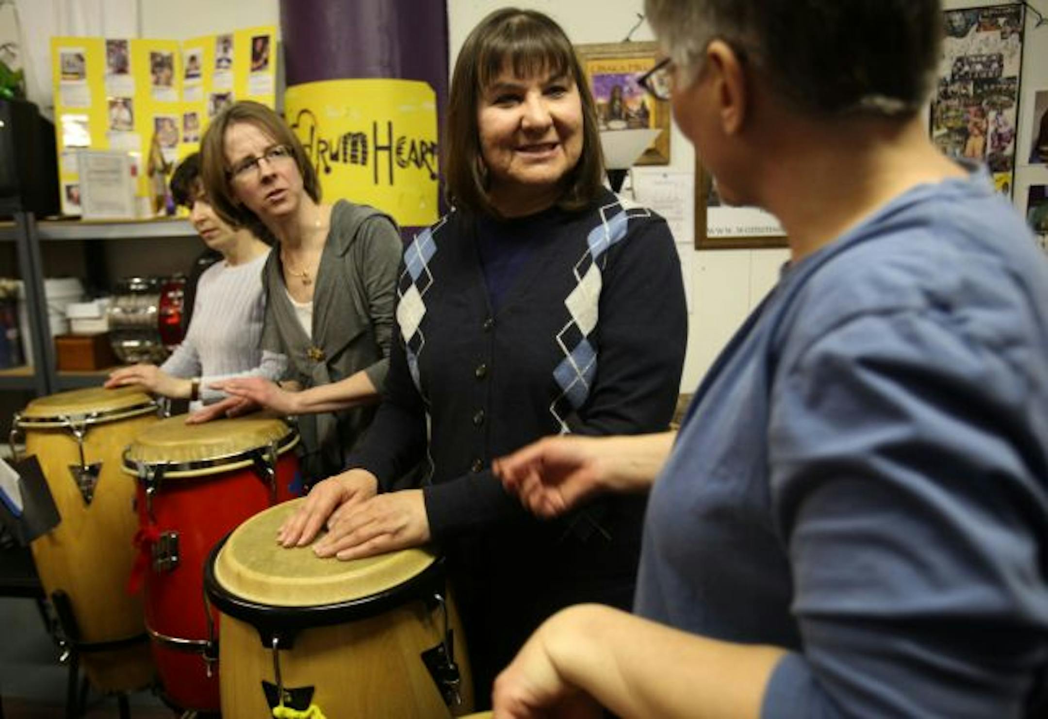 Sue Pomeroy, of Columbia Heights, and Jill Beyer, of Minneapolis, members of Women's Drum Center, chatted as they went over a section of a piece the group was playing.