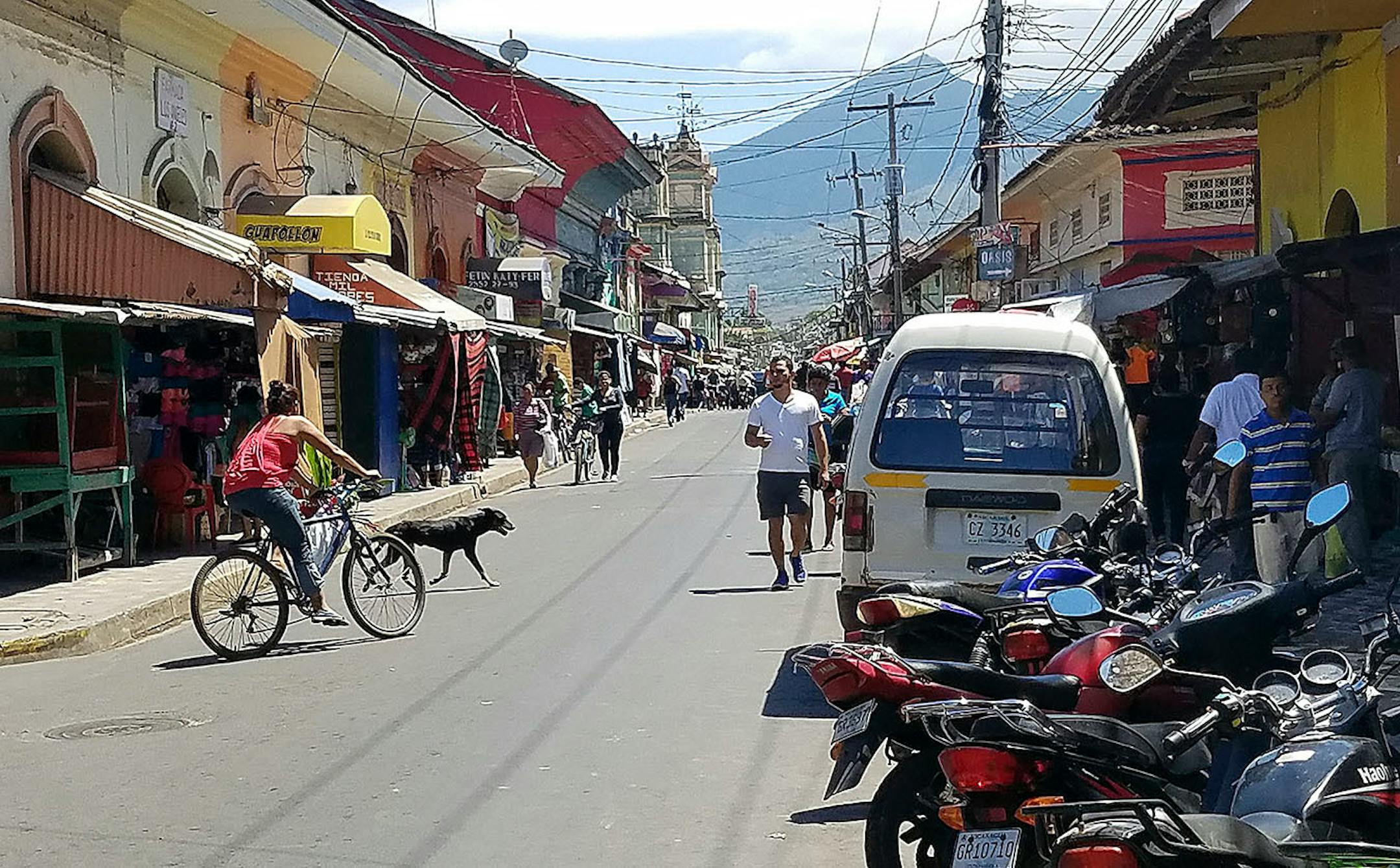 Motorcycles, markets and pedestrians line Calle Atravesada in Granada, Nicaragua, in the city's shopping corridor.