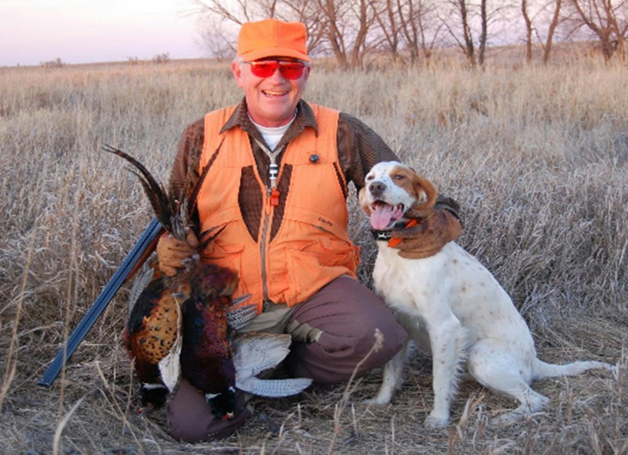 Rick Peifer of Wyoming, Minn., and Katie, his English setter, with pheasants they bagged. Photo courtesy Rick Peifer.