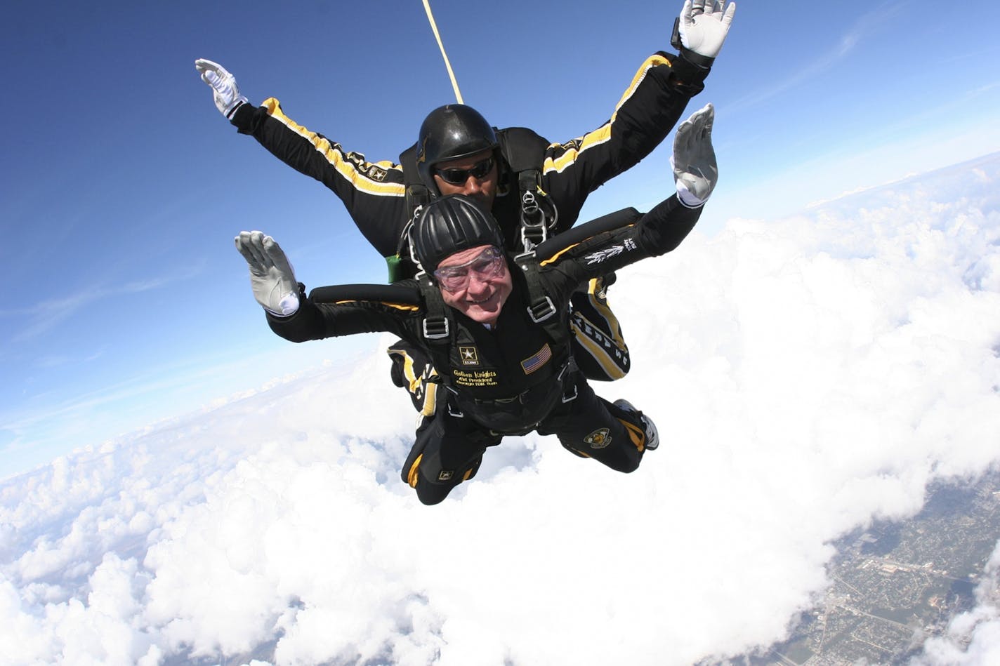 In this photo provided by the U.S. Army Golden Knights, Former President George H.W. Bush is shown during his free fall with U.S. Army Golden Knights parachute team member, Sgt. 1st Class Mike Elliott, as he made his entrance to his presidential museum during a rededication ceremony in College Station, Texas, on Saturday, Nov. 10, 2007.