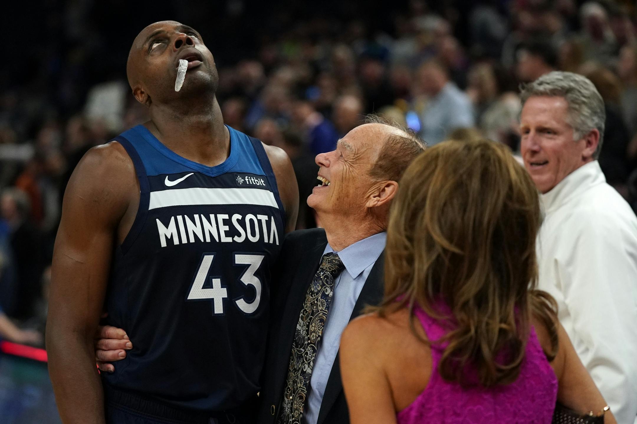 Minnesota Timberwolves forward Anthony Tolliver (43) was congratulated by team owner Glen Taylor and his wife Becky after the win over the Golden State Warriors in overtime.