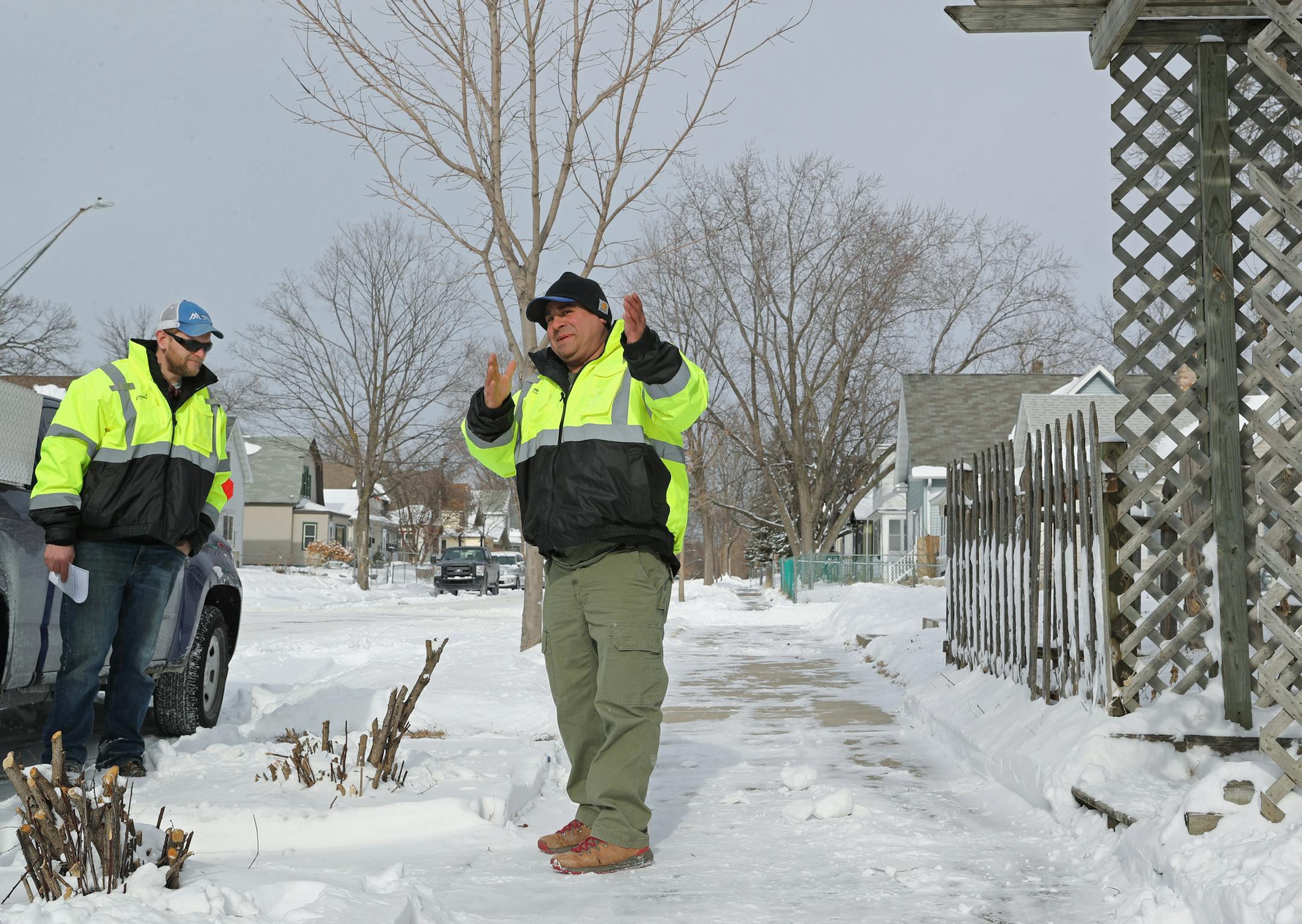 City workers Isaac Prehall, right, and Kevin Henke inspected sidewalks in north Minneapolis last winter, after the city launched a pilot program to check for residents who failed to shovel their sidewalks.
