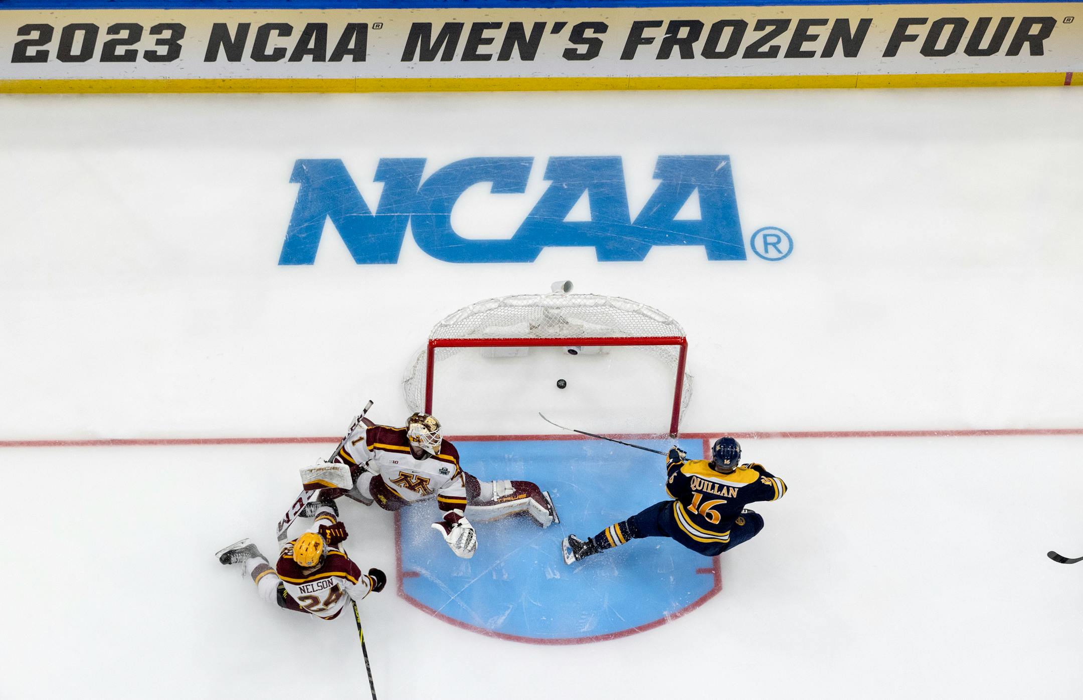Jacob Quillan (16) of Quinnipiac scores the game winner past Minnesota goalie Justen Close (1) in an overtime period.