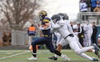 Mahtomedi running back Corey Bohmert (1) broke free for a long run in the second quarter but got caught by St. Thomas Academy defenders Jonathan Mille