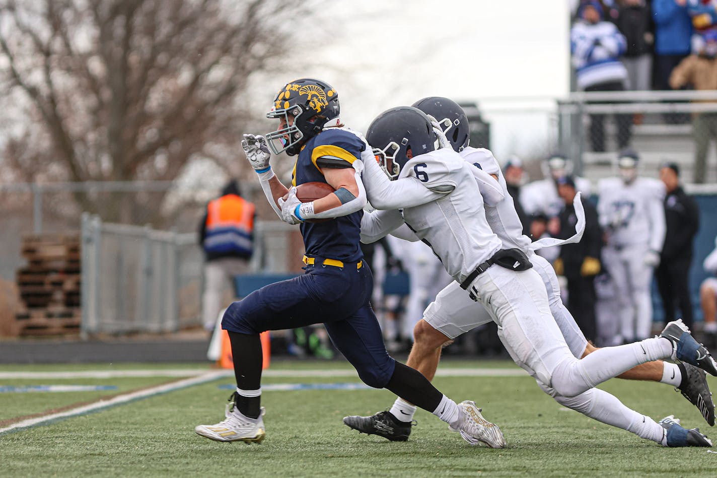 Mahtomedi running back Corey Bohmert (1) broke free for a long run in the second quarter but got caught by St. Thomas Academy defenders Jonathan Miller (6) and Mark Rogalski. Class 5A state football quarterfinals, St. Thomas Academy vs. Mahtomedi, 11-12-22. Photo by Mark Hvidsten, SportsEngine