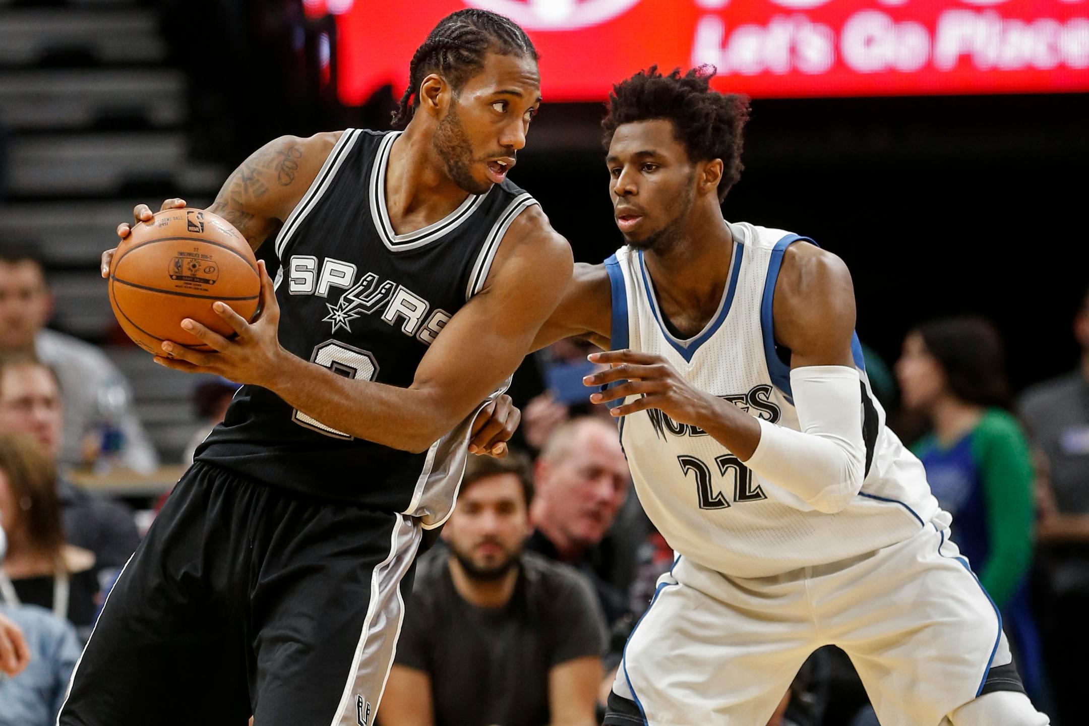 San Antonio Spurs forward Kawhi Leonard (2) works against Minnesota Timberwolves forward Andrew Wiggins (22) in the second half of an NBA basketball game, Tuesday, Dec. 6, 2016, in Minneapolis. The Spurs won 105-91. (AP Photo/Bruce Kluckhohn)