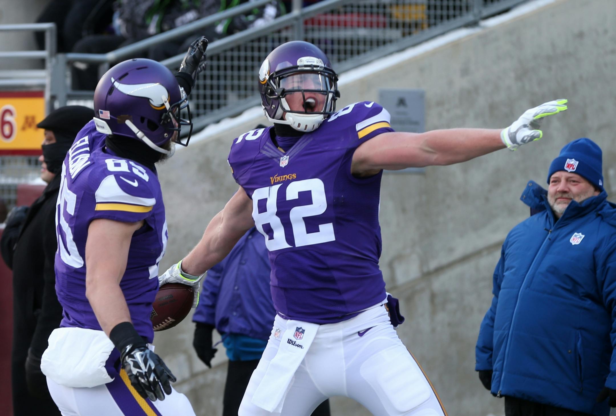 Minnesota Vikings tight end Kyle Rudolph, right, celebrates with teammate Rhett Ellison after catching a 4-yard touchdown pass during the first half of an NFL football game against the Carolina Panthers, Sunday, Nov. 30, 2014, in Minneapolis.