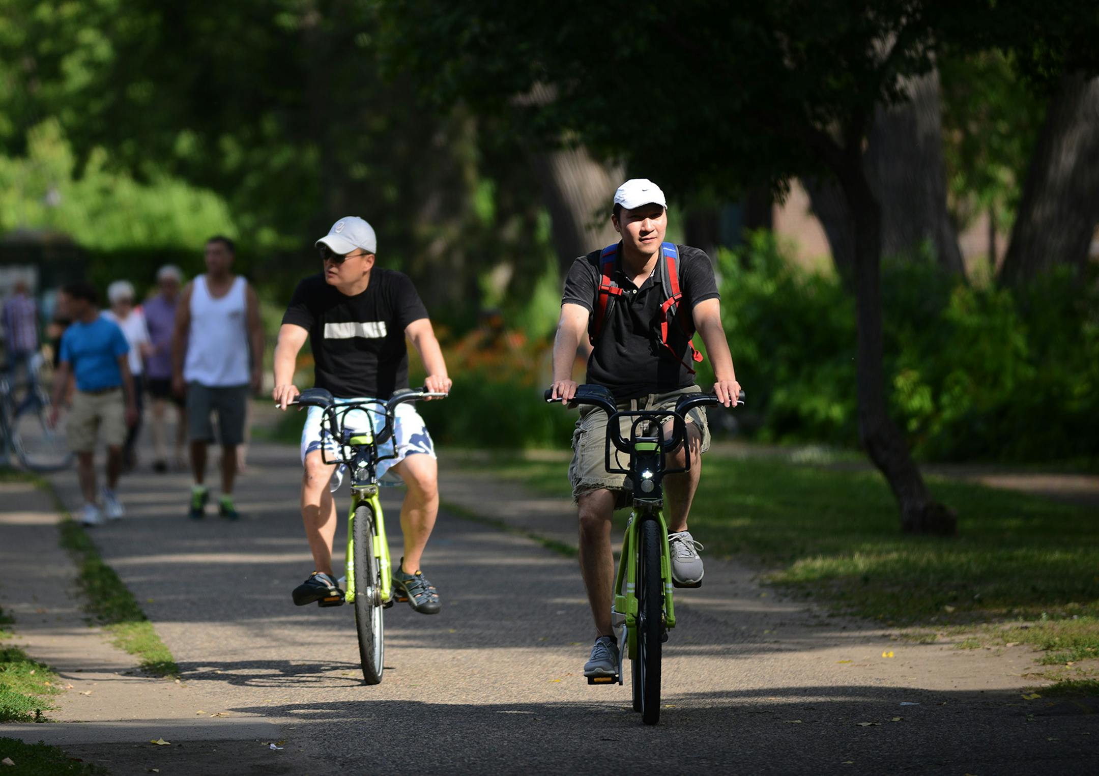 From left, Y.K. Cheong, of Washington, and Ken Tan, of Minneapolis, biked on SE Main St near St. Anthony Main in Minneapolis, Minn., on Saturday June 27, 2015. The Minneapolis Foundation gave away free 24-hour passes for the bike-sharing program at several stations in Minneapolis. ] RACHEL WOOLF · rachel.woolf@startribune.com