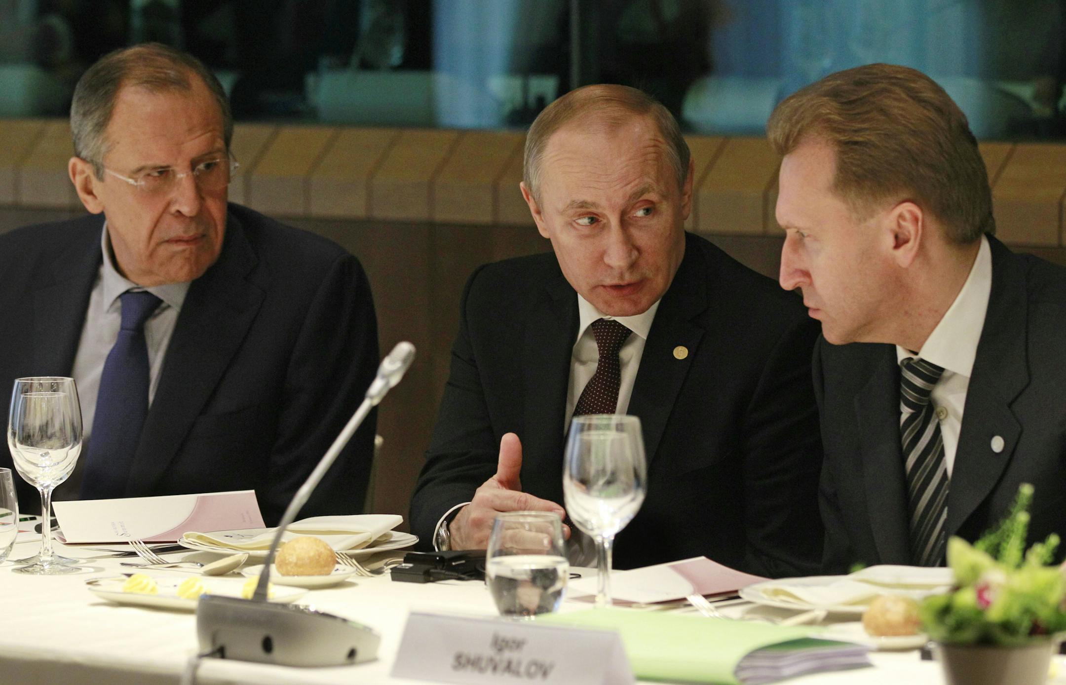 Russian President Vladimir Putin, center, with Russian Vice Prime Minister Igor Ivanovich Shuvalov, right, and Russian Foreign Minister Sergey Lavrov during a meeting at the European Council building in Brussels, Jan. 28, 2014. Putin arrived in Brussels on Tuesday amid tension between Russia and the European Union over the crisis in Ukraine. (Yves Logghe/Pool via The New York Times) -- EDITORIAL USE ONLY