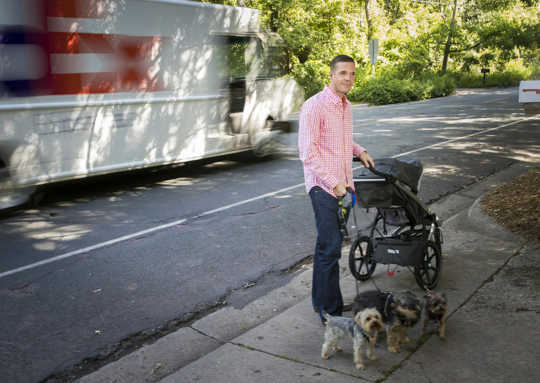 Josh Ahlberg has petitioned his neighborhood trying to get the city to put a sideway on his busy street Valley View Road. He is a dad and posed for a picture with his dogs and his daughter's stroller on Tuesday, July 12, 2016 in Edina, Minn. ] RENEE JONES SCHNEIDER • reneejones@startribune.com