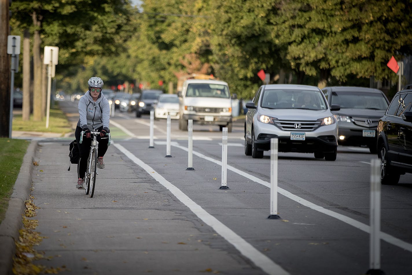 A bicyclist made her way down the bike lane during rush hour near Blaisdell Avenue and 26th Street, Friday, October 13, 2017 in Minneapolis, MN. New bike lanes are cropping up around the Twin Cities, creating a divide between cyclists who feel safer riding in a lane and motorists, residents and business owners frustrated by lost space for driving and parking. Many of the lanes have been added within the last five years, as a result of comprehensive bicycle master plans in both Minneapolis and St