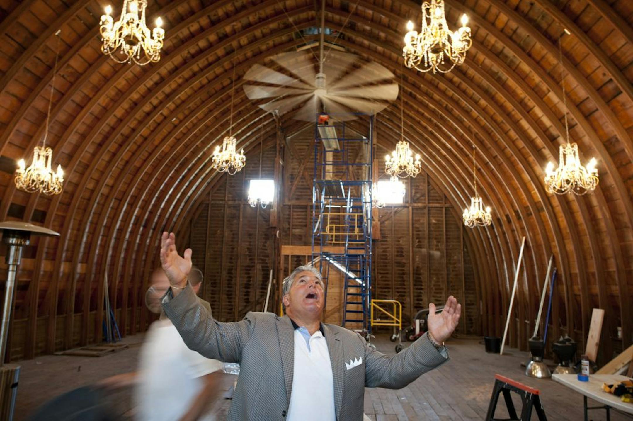 Steve Schussler showed off hanging crystal chandeliers in the barn's soaring interior.