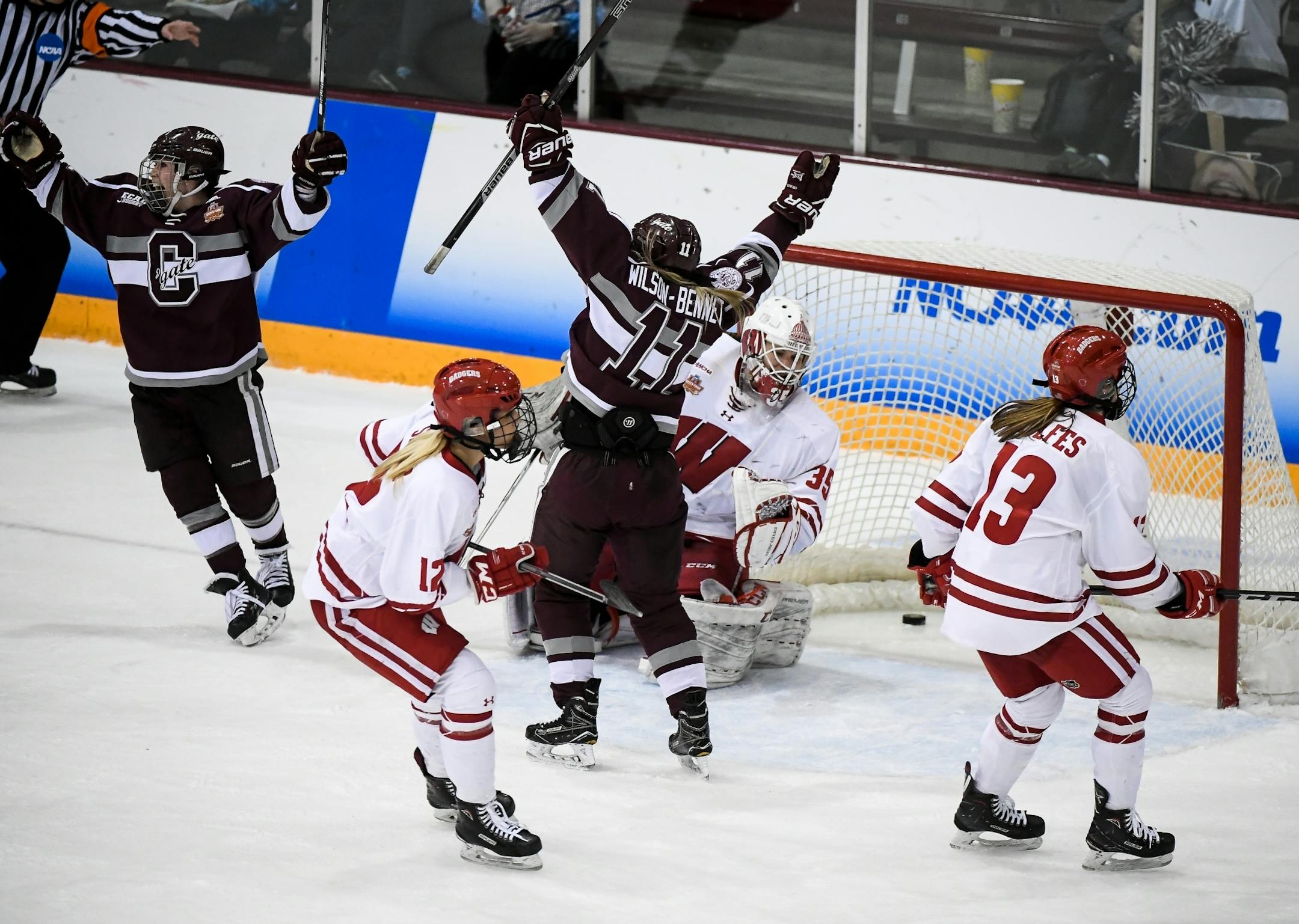 Colgate Raiders forward Bailey Larson (61) and forward Breanne Wilson-Bennett (11) celebrated a second period goal by forward Megan Sullivan (7) against Wisconsin Badgers goaltender Kristen Campbell (35).