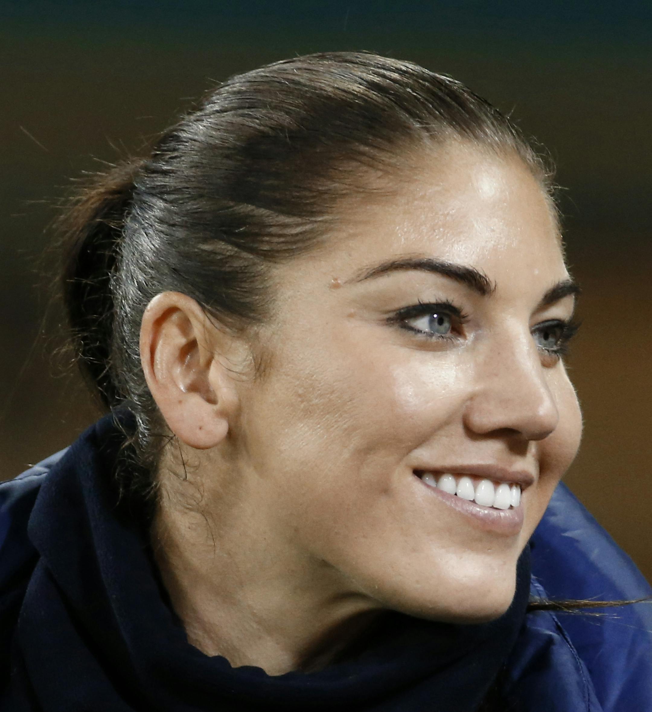 FILE - In this Oct. 20, 2014, file photo, U.S. goalkeeper Hope Solo stands on the sidelines before a CONCACAF soccer match against Haiti in Washington. Solo was reinstated by U.S. Soccer after a 30-day suspension and is on the travel roster for next month's Algarve Cup in Portugal. (AP Photo/Alex Brandon, File)