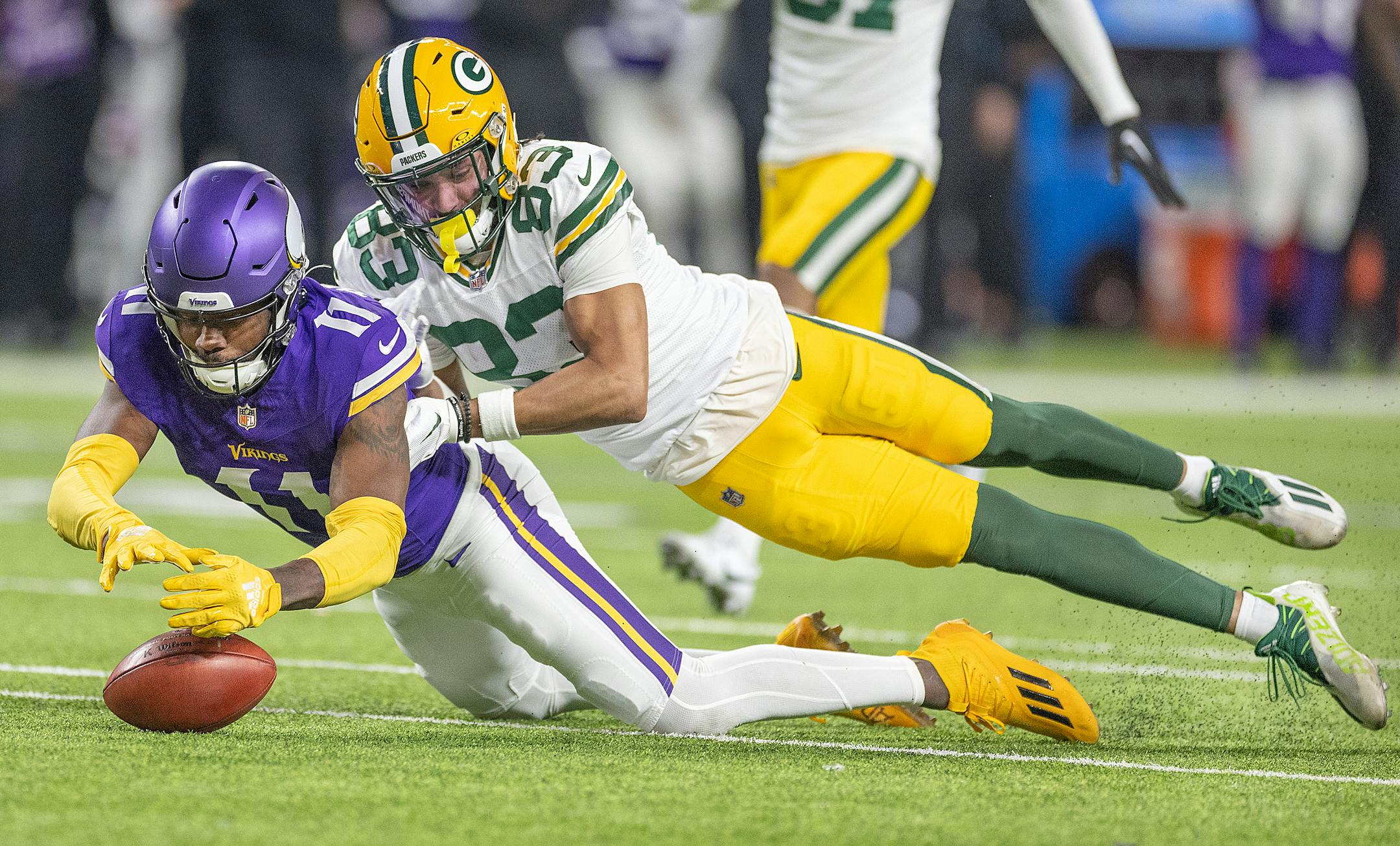 Vikings cornerback NaJee Thompson (11) recovers a fumble in a failed punt return to Packers wide receiver Samori Toure (83) in the fourth quarter at U.S. Bank Stadium, in Minneapolis, Minn., on Sunday, Dec. 31, 2023. ] Elizabeth Flores • liz.flores@startribune.com