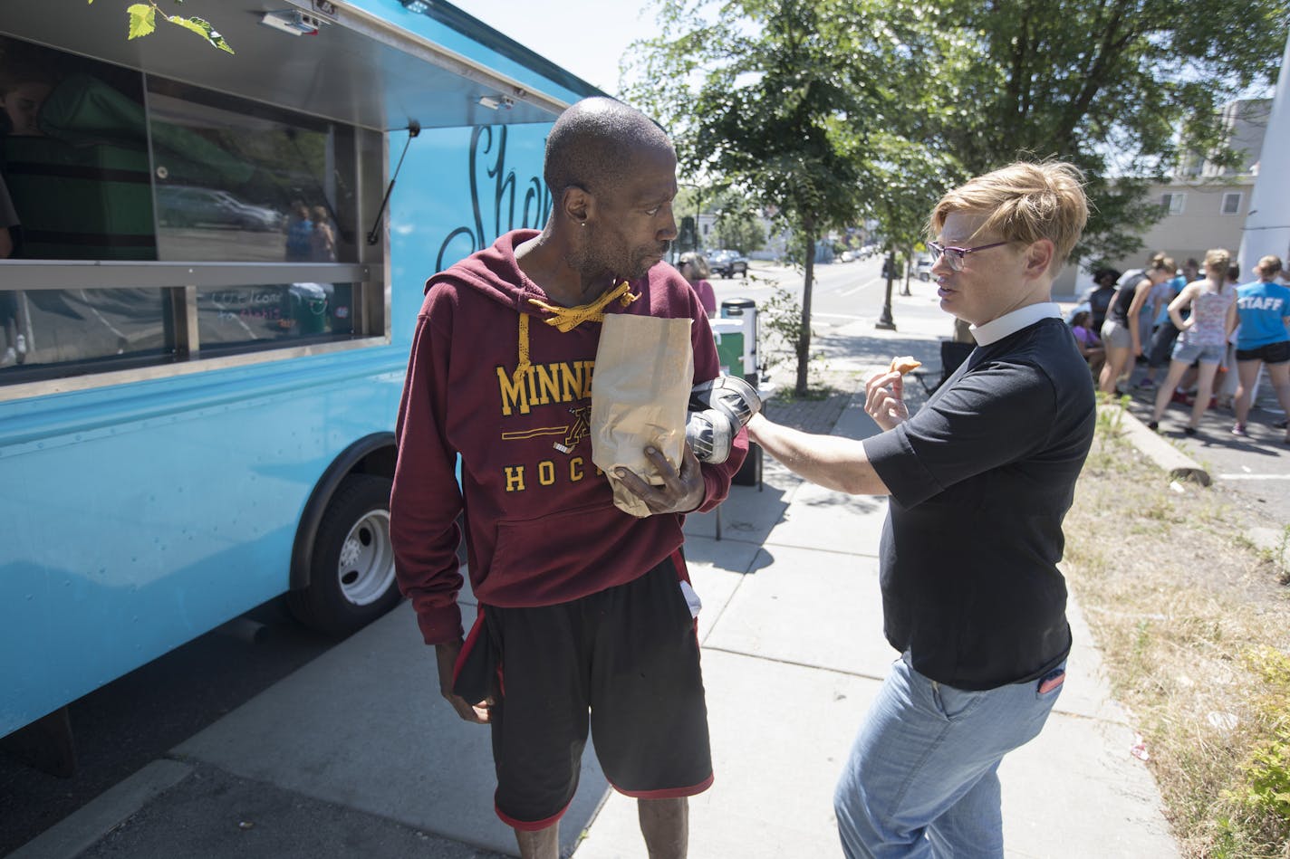 Pastor Margaret Kelly right , talked with Lucky King who picked up food from Shobi's Table food truck Thursday July 6, in St. Paul, MN. ] JERRY HOLT &#xef; jerry.holt@startribune.com