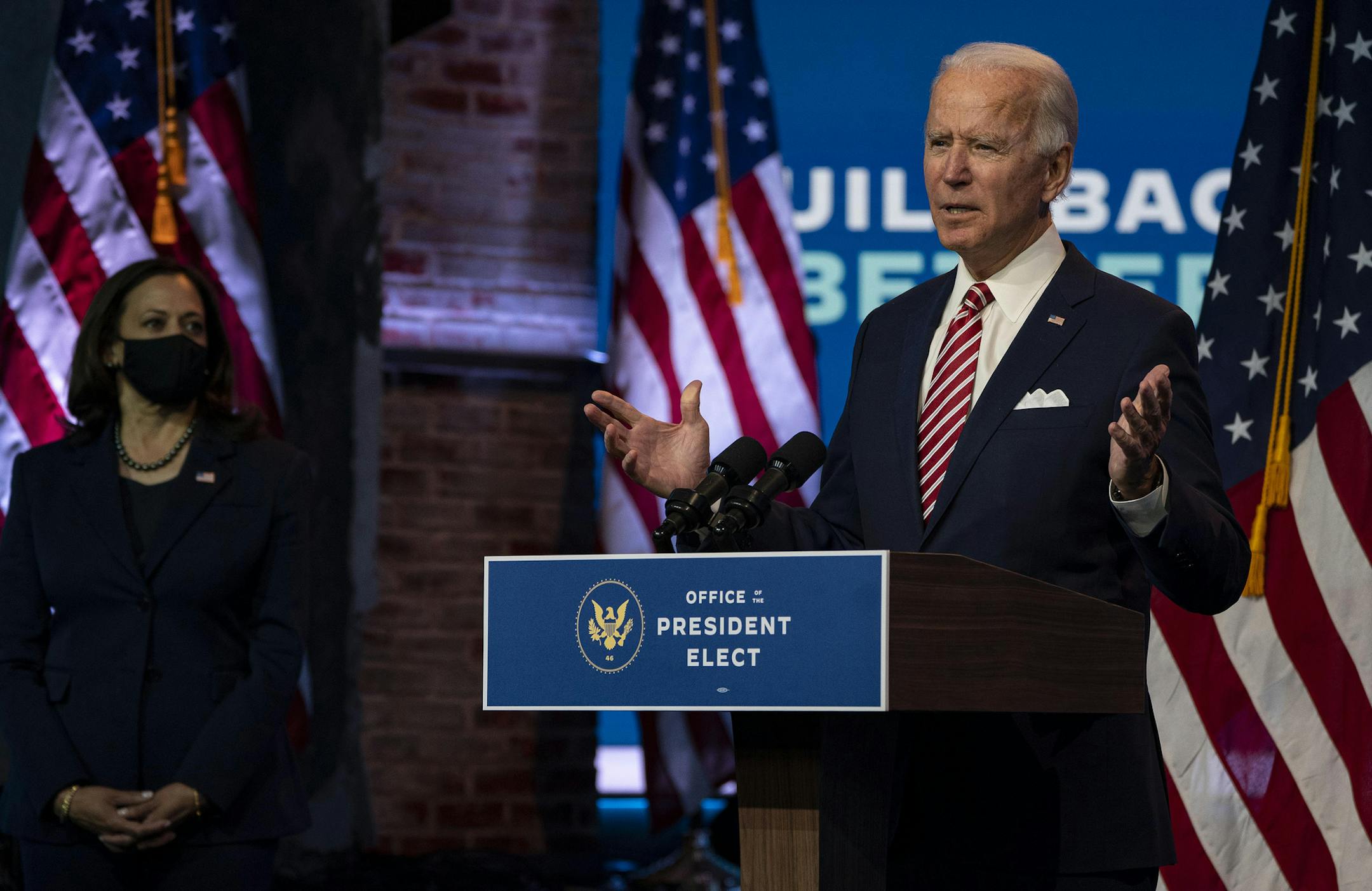 President-elect Joe Biden speaks about the economic recovery from the coronavirus pandemic as Vice President-elect Kamala Harris watches, at The Queen theater in Wilmington, Del., on Monday, Nov. 16, 2020. Biden sharpened his criticism of President Donald Trump's refusal to cooperate in an orderly transition, warning that "more people may die" from the coronavirus as a result of the president's refusal to coordinate planning for the mass distribution of a COVID-19 vaccine. (Ruth Fremson/The New