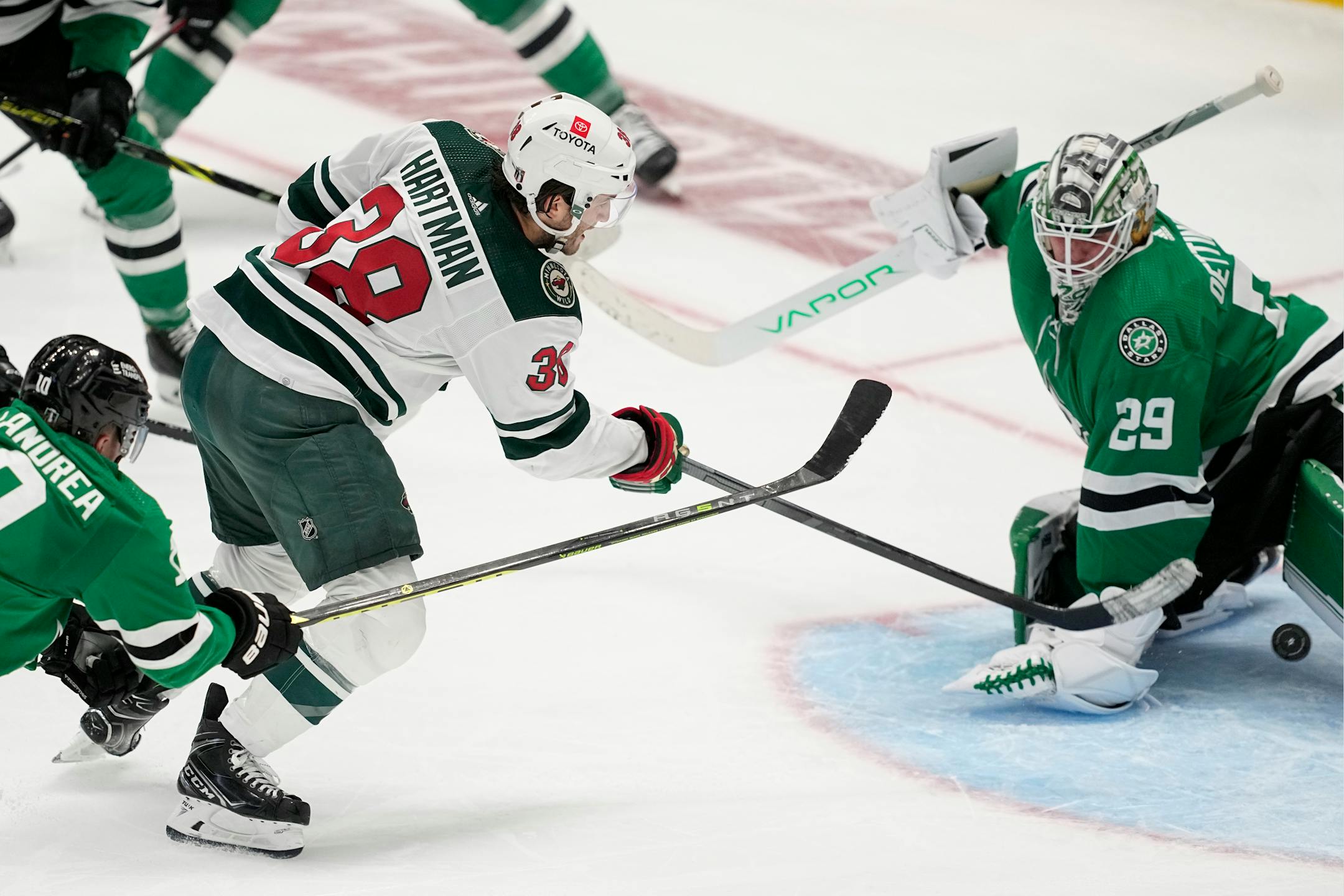 Minnesota Wild right wing Ryan Hartman (38) shoots and scores against Dallas Stars goaltender Jake Oettinger (29) in the second overtime of Game 1 of an NHL hockey Stanley Cup first-round playoff series, Tuesday, April 18, 2023, in Dallas. The Wild won 3-2.