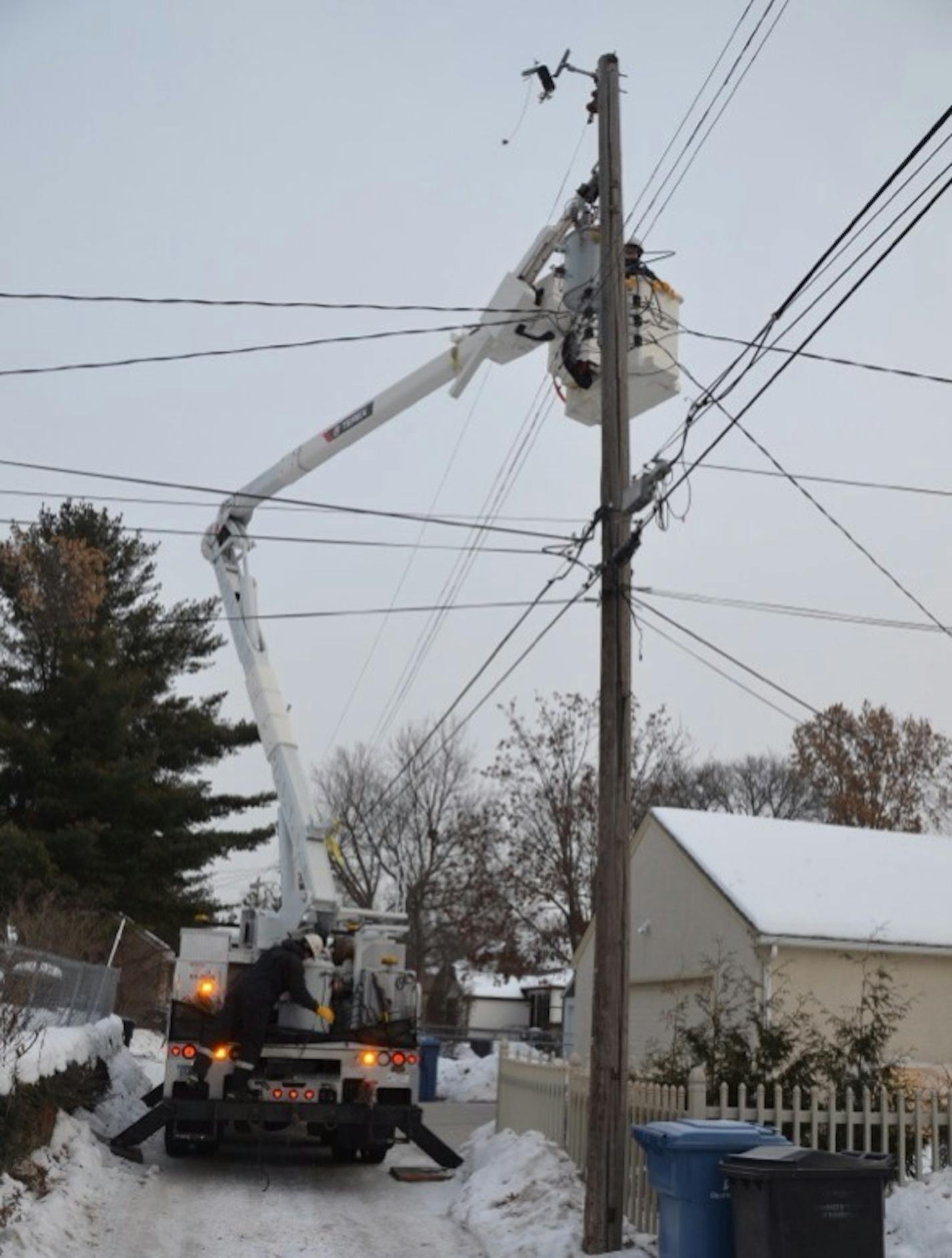 An electrical worker replaces parts in an alley on 23rd Ave. S., restoring power after more than 12 hours to a block in the Standish-Ericsson neighborhood of south Minneapolis.